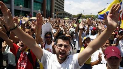 Anti-government protesters march during a demonstration in Caracas