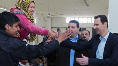 Government hand out picture of PResident Assad visiting a shelter