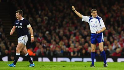 Scotland's Stuart Hogg is shown a red card for a late hit on Wales' Dan Biggar at the Millennium Stadium on Cardiff.