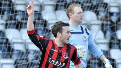 Eamon McAllister celebrates scoring against Ballymena for Crusaders