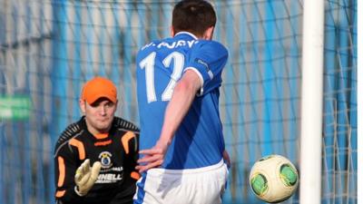 Linfield's Billy Joe Burns shoots past Gareth Buchanan of Dungannon Swifts