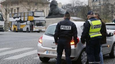 Police with motorist in Paris