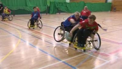 Members of wheelchair rugby club in training