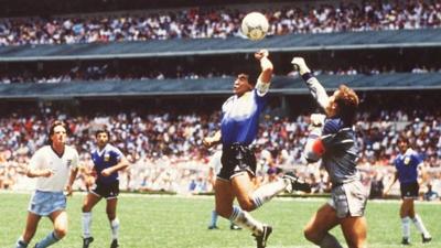 Argentina's Maradona uses his hand to beat England's Peter Shilton to the ball