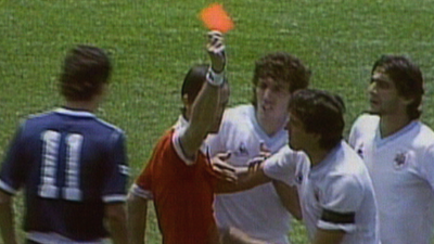 Referee Joel Quiniou sends off Uruguay's Jose Batista against Scotland