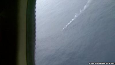 Footage from the Royal Australian Air Force P-3 Orion aircraft shows a smoke marker next to one of the objects