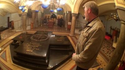 Man looking at a memorial