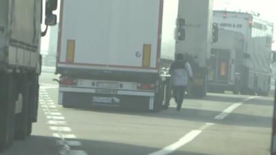 Migrant running towards lorry in Calais