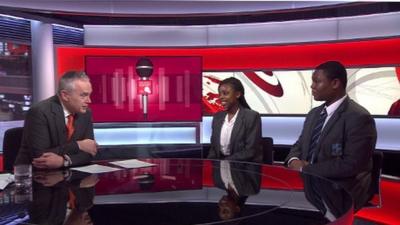 Huw Edwards with pupils Derek and Nicole from St Michael's Catholic College in south London