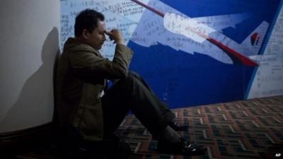 Chinese man in front on MH370 tribute wall