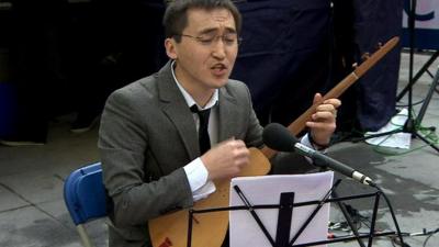 A BBC journalist performing outside the BBC headquarters in London