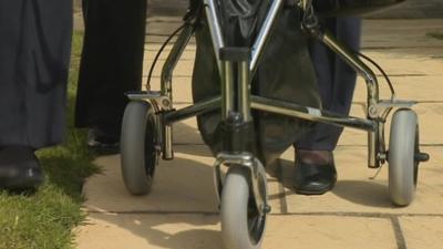 Woman using zimmer frame