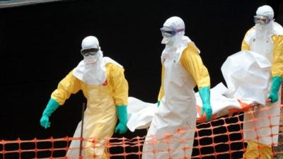 MSF aid organisation carry the body of a person killed by the Ebola virus in Guinea