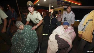 Elderly are evacuated from their shelter after a tsunami alarm at Antofagasta city