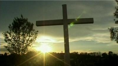 Cross with sun in background