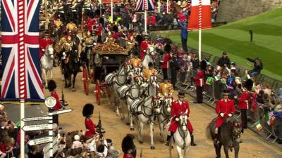 Royal carriage passes through Windsor on the way to the castle