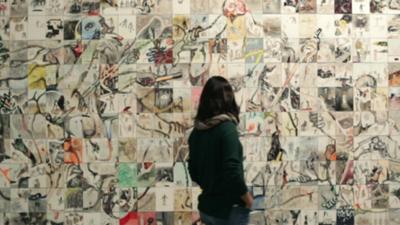 A visitor looking at an artwork in the Istanbul Modern museum