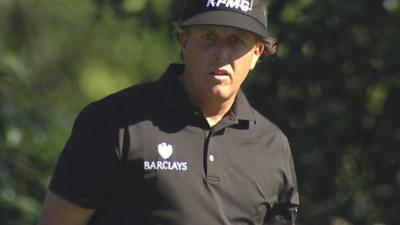 Phil Mickelson reacts after holing a "miracle" putt at the 10th hole in the Masters