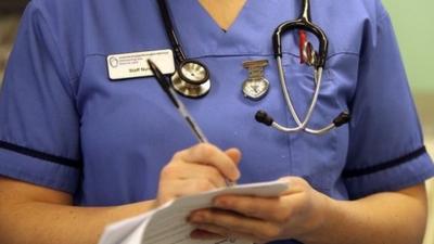 A nurse writing up notes