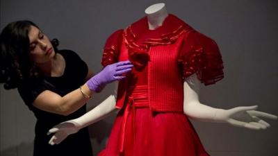 Assistant curator Lucia Savi with Valentino dress from 1977