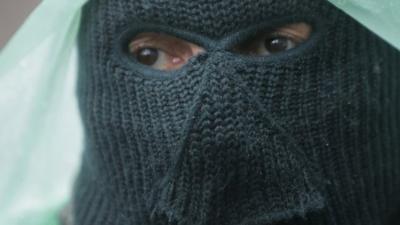 A pro-Russian gunman stands guard at a seized police station in the eastern Ukraine town of Sloviansk