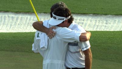 Bubba Watson hugs his caddie as he wins the 2014 Masters