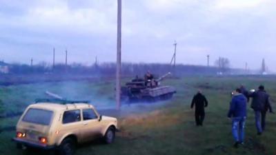 Still from unverified amateur footage purportedly showing Lada car chasing tank