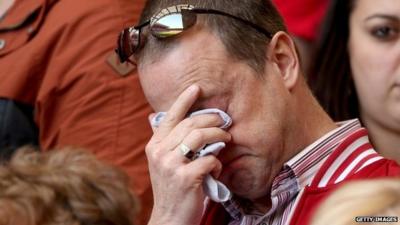 Liverpool supporter wiping tears