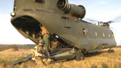 Soldier and Chinook helicopter