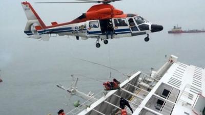 A helicopter rescues passengers who were on the South Korean ferry