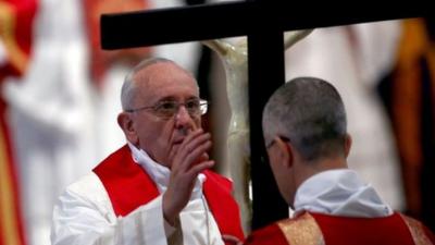 Pope Francis kisses the cross as he attends a Papal Mass with the Celebration of the Lord's Passion inside St Peters Basilica on April 18