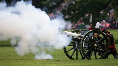 Members of the public watch as the Kings Troop Royal Horse Artillery, fire a 41 Gun Royal Salute performed in honour of Britains Queen Elizabet"s 88th birthday, in Green Park, London