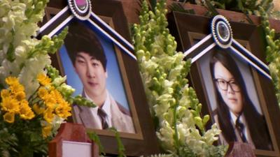 Photographs of victims at a memorial service