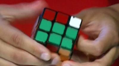 Man solving Rubik's Cube