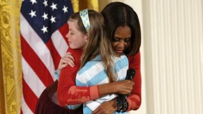 First Lady Michelle Obama hugs Charlotte Bell, at the White House's annual Take Our Daughters and Sons to Work Day 24 April 2014