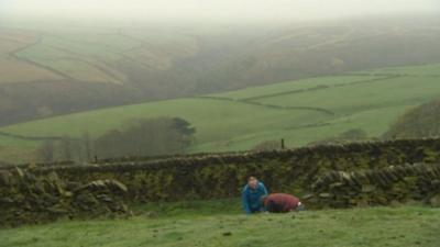 Two men near a dry stone wall