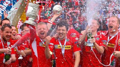 Cliftonville players celebrate lifting the Gibson Cup at Solitude