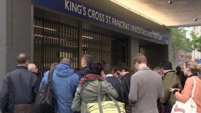 Commuters queuing outside Kings Cross tube station