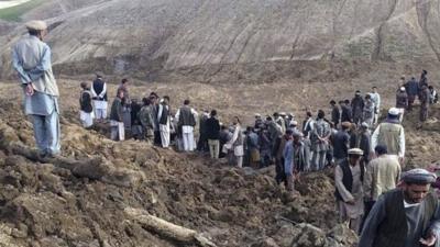 Afghan villagers gather at the site of a landslide at the Argo district in Badakhshan province