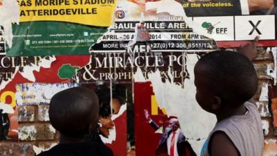 Young boys look at Economic Freedom Fighters (EFF) election posters in Atteridgeville, west of Pretoria, South Africa, 5 May 2014