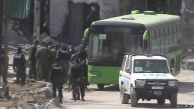 Police and passengers next to bus