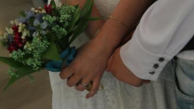 Hands of gay couple at their wedding