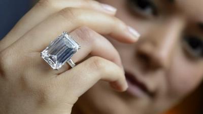 A Sothebys employee shows the Victory Diamond.