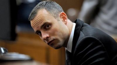 South African Paralympic athlete Oscar Pistorius sits in the dock during his ongoing murder trial, in Pretoria