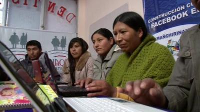 Bolivians working on laptop computers