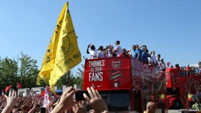 Players on board open top bus