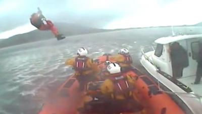 Paramedic winched aboard lifeboat