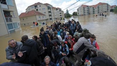 A group is evacuated on an amphibious vehicle over flooded streets in the town of Obrenovac