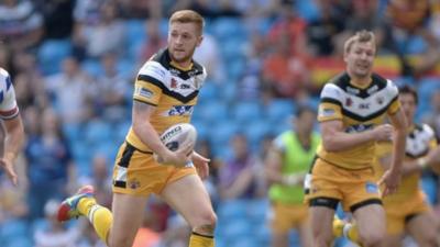 Castleford half-back Mark Sneyd scores one of his two second half tries as the Tigers mauled local rivals Wakefield Trinity Wildcats at the Etihad Stadium.