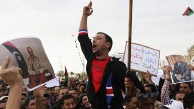 Men carrying pictures of former Libyan commander Major General Khalifa Haftar